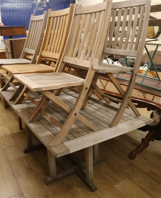 A set of six folding garden chairs and a teak garden table, with two extending leaves, L.180cm